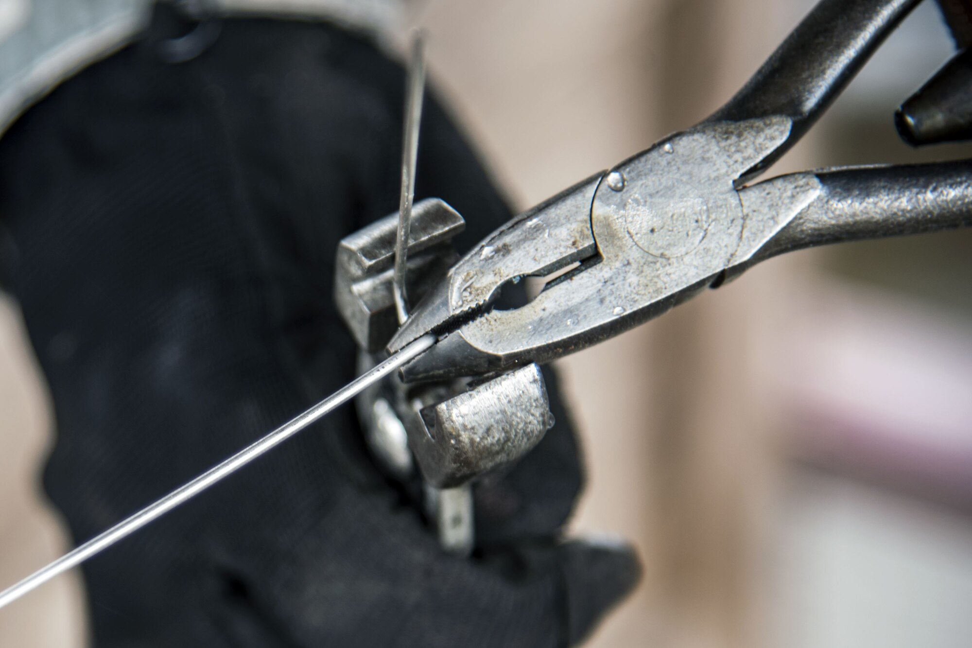 Staff Sgt. John Beeson, 23d Maintenance Squadron (MXS) munitions inspector, cuts a wire, Jan. 11, 2018, at Moody Air Force Base, Ga. The 23d MXS held a combat munitions class to help acclimate and improve their Airmen’s readiness to perform well in a deployed environment.  (U.S. Air Force photo by Airman Eugene Oliver)