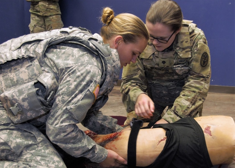 Combat medics at William Beaumont Army Medical Center’s Inpatient Surgical Unit, apply a tourniquet to a simulated casualty during tactical combat casualty care training at the Medical Simulation Training Center at Fort Bliss, Texas.