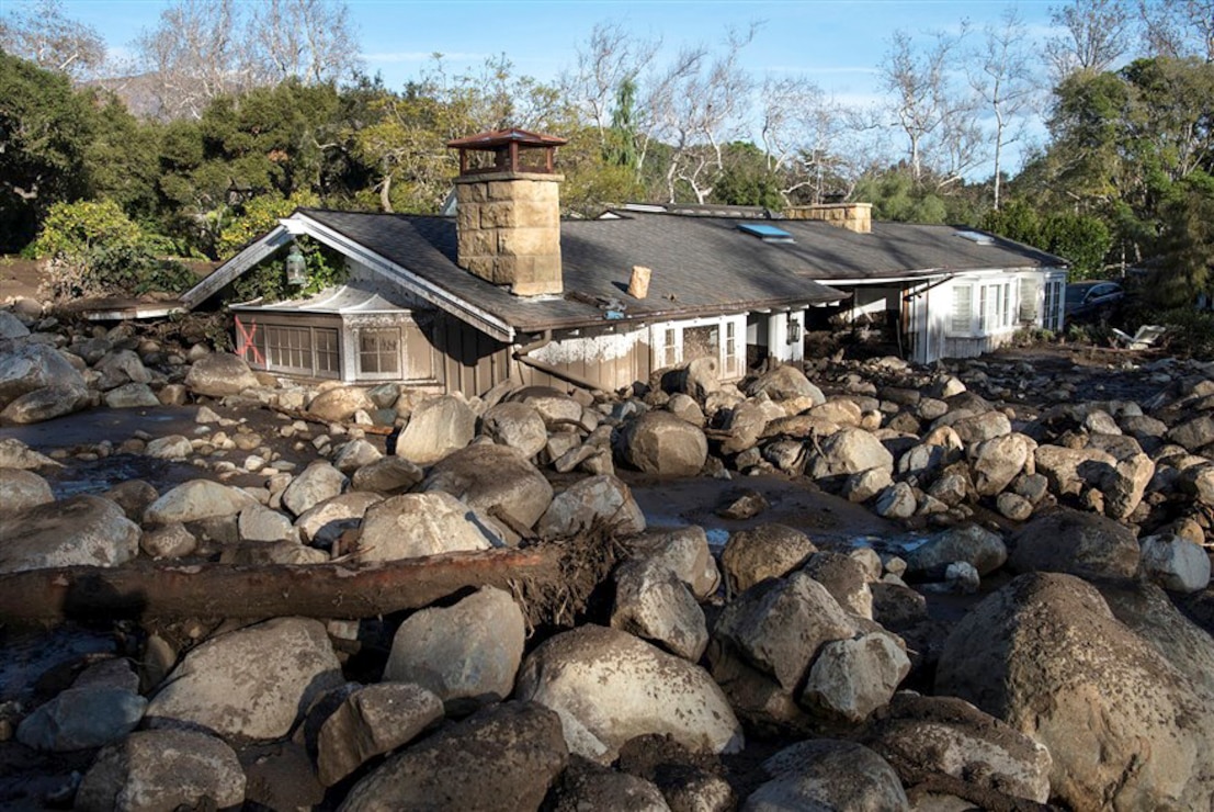 Boulders from a mudslide surround a damaged home on Glen Oaks Road in Montecito, California on Jan. 10