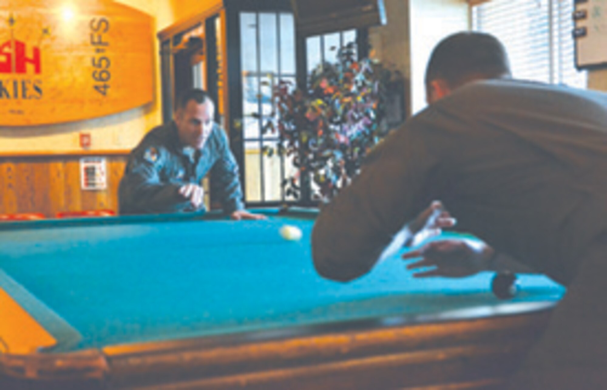 Maj. Timothy Ewing serves against a 965 Airborne Air Control Squadron blocker during 2018’s first crud tournament at Rosie’s Officer Lounge at the Tinker Club. A physical game that often results in injuries and rumpus banter, crud tournaments are hosted at Rosie’s during the first Friday of every month at 4:30 p.m.