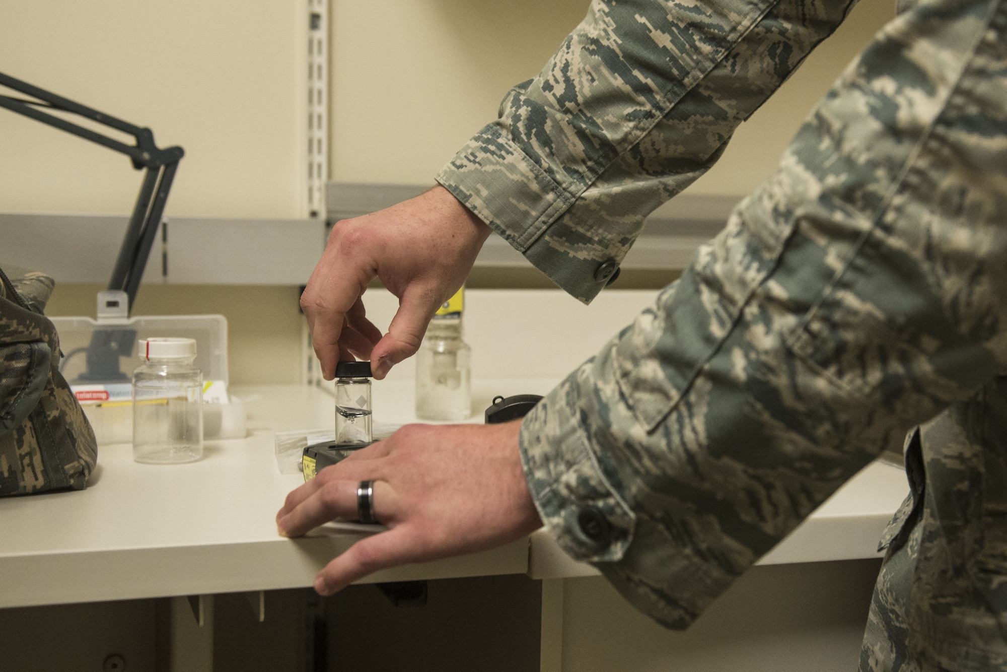 U.S. Air Force Airman 1st Class Jackson Gordon, 20th Aerospace Medicine Squadron bioenvironmental apprentice, places a vial of water into a pocket colorimeter, which measures chlorine, at Shaw Air Force Base, S.C., Jan. 12, 2018.