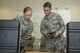 U.S. Air Force Senior Airman Selina Chavez, 20th Aerospace Medicine Squadron (AMDS) bioenvironmental journeyman, left, asks Airman 1st Class Jackson Gordon, 20th AMDS bioenvironmental apprentice, a question about the ADM-300 test kit at Shaw Air Force Base, S.C., Jan. 12, 2018.