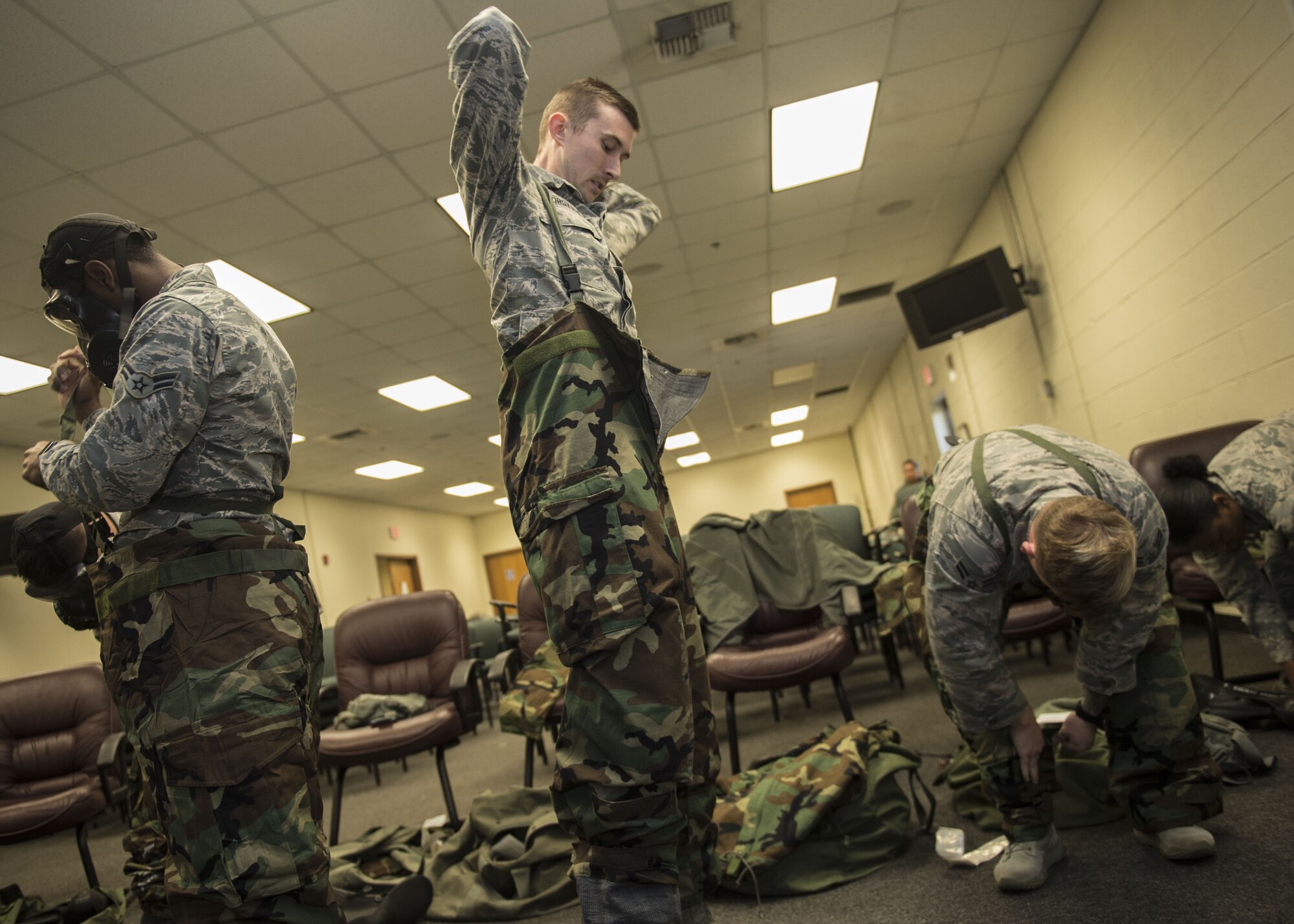 Airmen assigned to Altus Air Force Base, Okla., practice donning Mission Oriented Protective Posture (MOPP) gear, Jan. 10, 2018, at Altus AFB.