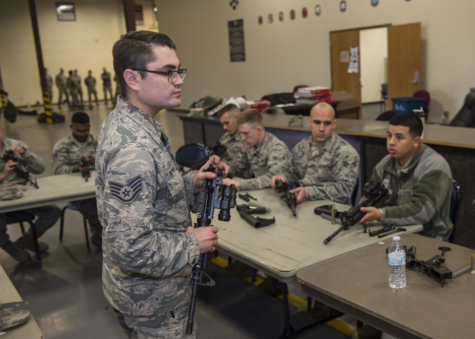 U.S. Air Force Staff Sgt. Cody Reynolds, combat arms instructor assigned to the 97th Security Forces Squadron, instructs Airmen on weapon assembly, Jan. 10, 2018, at Altus Air Force Base, Okla.