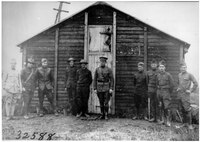 Soldiers stand in front of an aero intercept station.  These stations collected messages sent by enemy aircraft and alerted Allied forces to artillery movements or directed Allied pursuit squadrons.