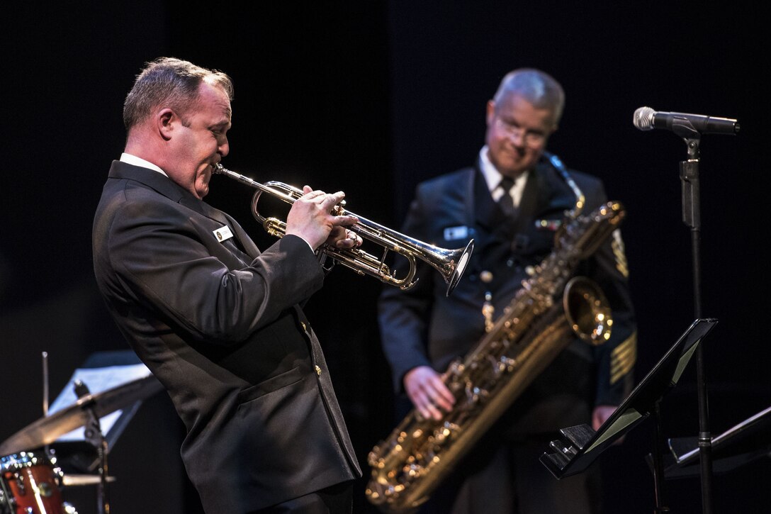 Two sailors perform during a saxophone symposium.
