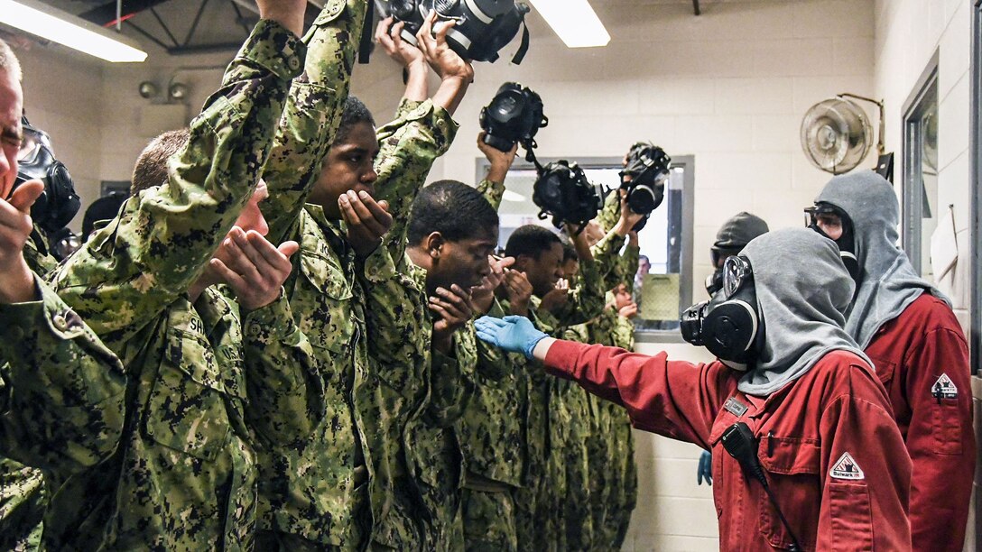 Recruits recite their names and division numbers while experiencing the effects of tear gas.