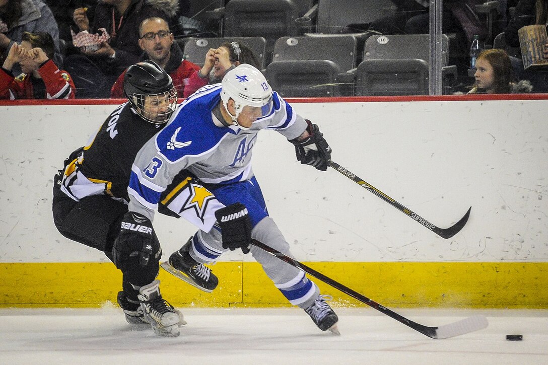 Airmen and soldiers compete in the 5th annual Army vs. Air Force hockey game.