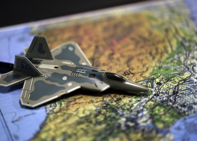 An F-22 Raptor model is shown on a map during an unclassified 325th Operations Support Squadron intelligence briefing at Tyndall Air Force Base, Fla., Oct. 25, 2017. The 325th OSS Intel flight works behind the scenes analyzing and assessing information then disseminating the pertinent information to allow for better decision making. (U.S. Air Force photo by Airman 1st Class Isaiah J. Soliz/Released)