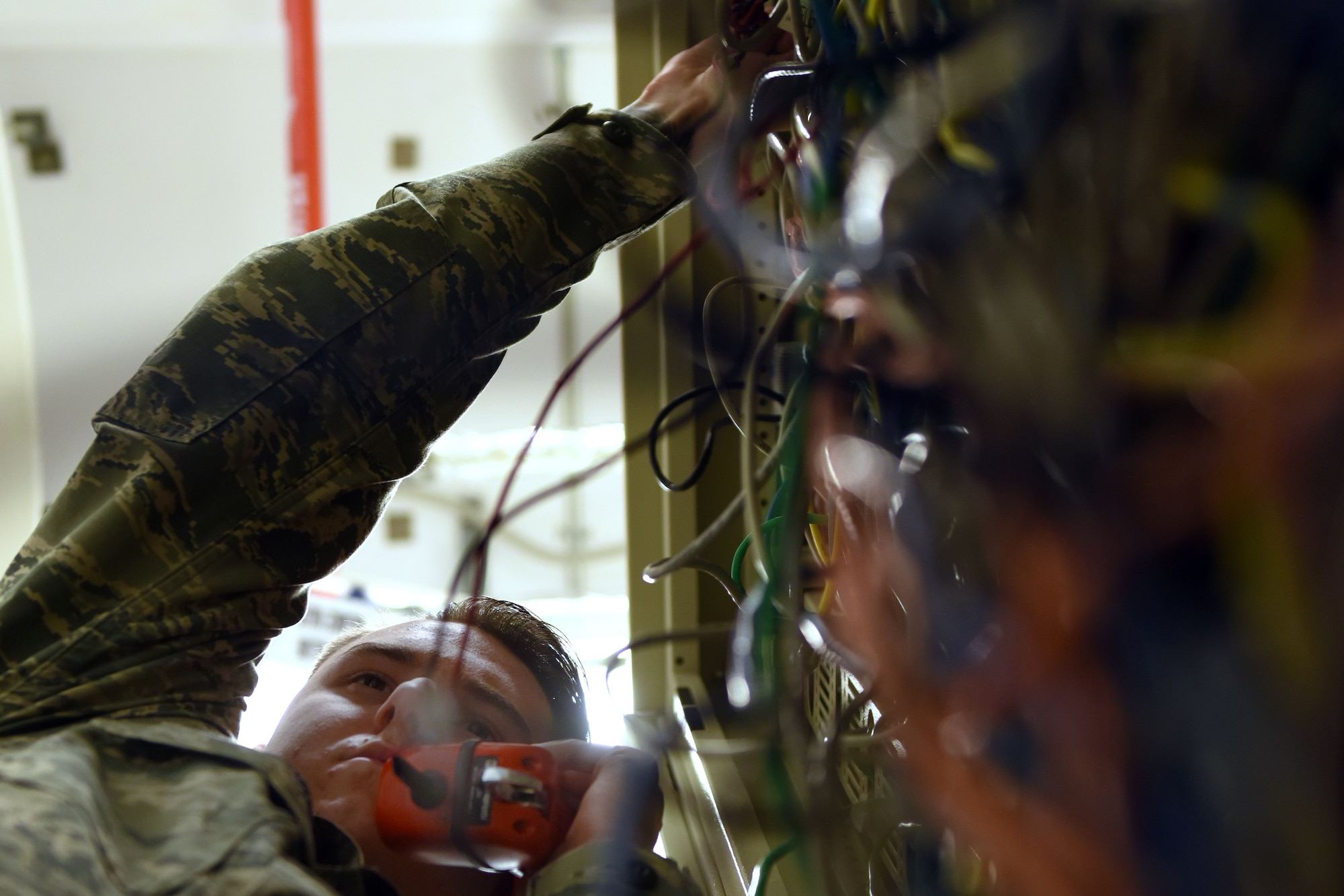 U.S. Air Force Airman 1st Class Chad Humphries, 39th Communications Squadron cyber transport technician, tests the voice and networking signals on a 66 punch down block using a tone tester set.