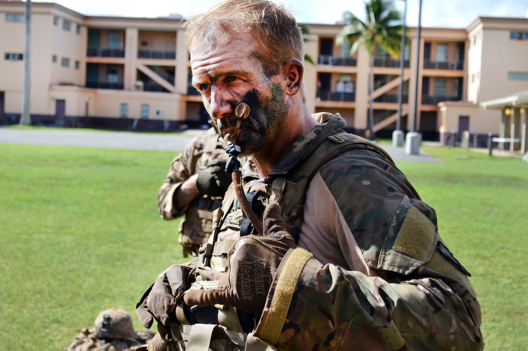 Army Capt. Jeffrey Hubler takes a water break after completing the final road march.