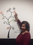 Rita was recognized by a fellow employee and is placing her leaf on the Appreciation Tree in the BS224 Conference Room.