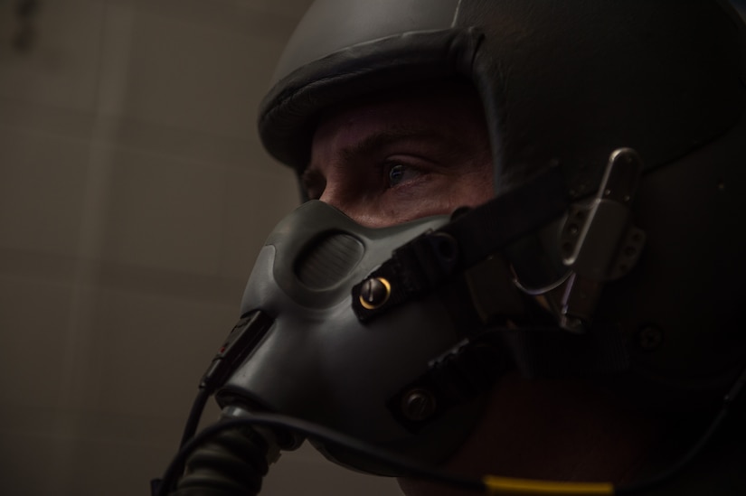 U.S. Air Force Lt Col Samuel Mcintyre, NATO Allied Command Transformation deputy chief of staff military assistant, breaths through a mask as he flies a flight simulator during hypoxia training at 1st Operations Group aerospace and operational physiology, Joint Base Langley-Eustis, Va., Dec. 5, 2017. Hypoxia is when the heart and/or lungs can’t provide the blood with the proper amount of oxygen causing the brain and other organs to start failing. (U.S. Air Force photo by Airman 1st Class Tristan Biese)