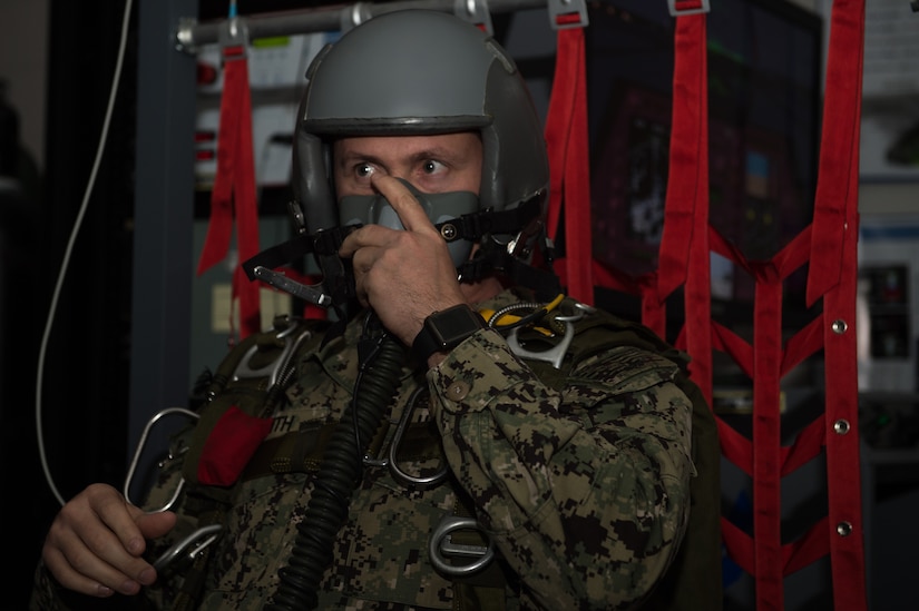 U.S. Navy Chief Petty Officer, Explosive Ordnance Disposal Mobile Unit 12 EOD chief, tests his breathing mask during hypoxia training at 1st Operations Group aerospace and operational physiology, Joint Base Langley-Eustis, Va., Dec. 5, 2017. AOP not only trains pilots but also trains individuals from other branches of the military and other career fields. (U.S. Air Force photo by Airman 1st Class Tristan Biese)