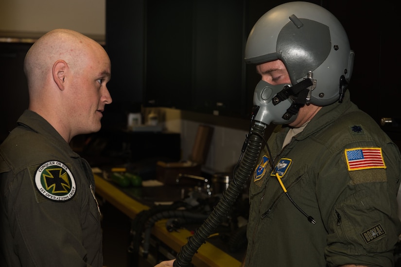 U.S. Air Force Staff Sgt. Dylan Crump, 1st Operations Group aerospace and operational physiology technician, test fits a mask onto Lt Col Samuel Mcintyre, NATO Allied Command Transformation deputy chief of staff military assistant, at 1st OG AOP, Joint Base Langley-Eustis, Va., Dec. 5, 2017. The department trains individuals to understand and recognize the symptoms they may receive while becoming hypoxic. (U.S. Air Force photo by Airman 1st Class Tristan Biese)