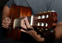 A student from the Woodside High School orchestra guitar ensemble performs a musical piece at Fort Eustis’ Wylie Theater during the Dr. Martin Luther King, Jr. Birthday Celebration at Joint Base Langley-Eustis, Va., Jan. 11, 2018.
