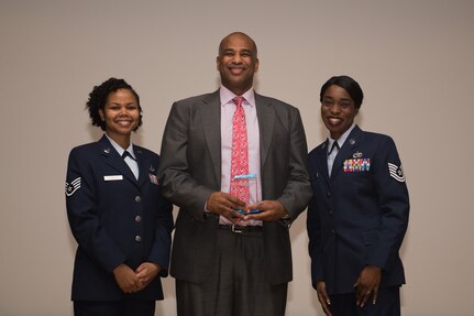Wayne Gomes, former Major League Baseball player, poses for a photo after receiving an appreciation plaque from U.S. Air Force Staff Sgt. Carla Christie, 439th Supply Chain Operations Squadron A-10 weapon system manager (left), and Tech. Sgt. Kennesha Key, 441st Vehicle Support Chain Operations Squadron Air Force vehicle fleet support supervisor (right), during the Dr. Martin Luther King Jr. Day event at Joint Base Langley-Eustis, Va., Jan. 12, 2018.
