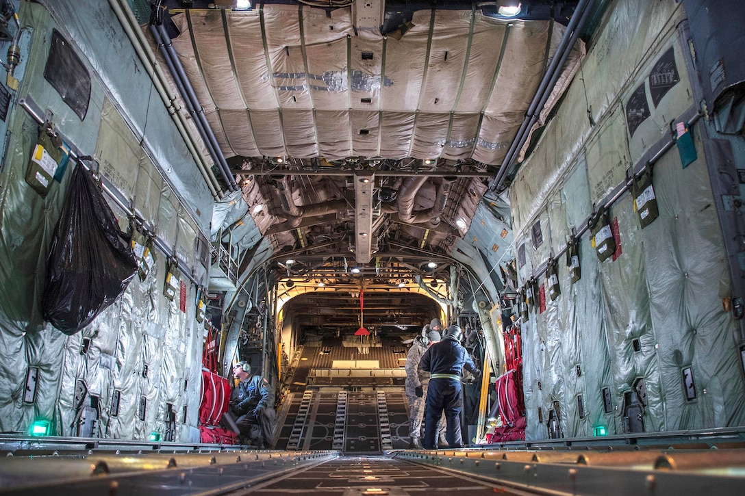 Tech. Sgt. Chris Brandal, left, performs pre-flight inspections inside a C-130H Hercules aircraft.