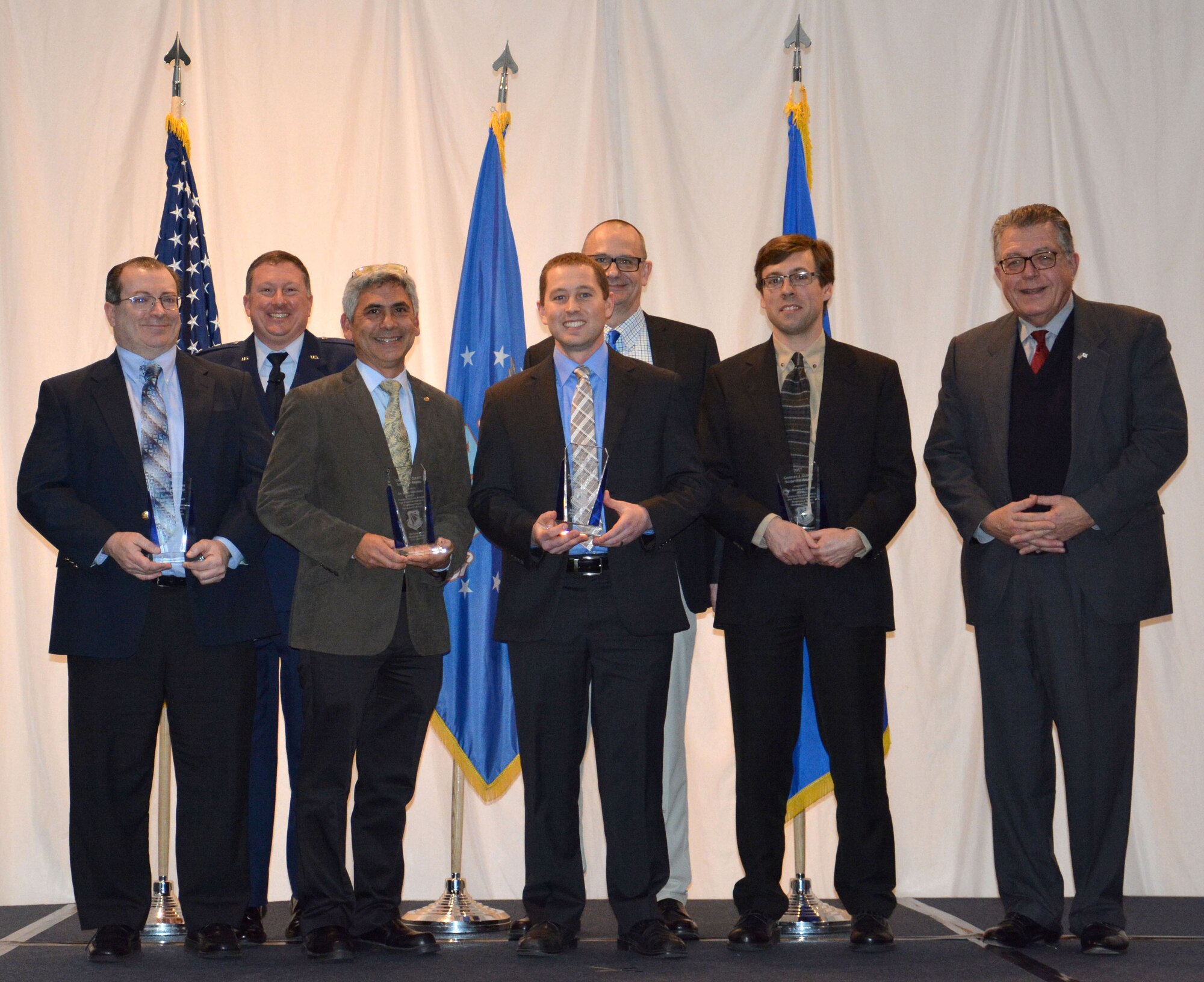 Michael Cleary presented the directorate’s most prestigious award, the Charles J. Cleary Scientific Achievement Award, to the Flexible Gallium Nitride for High Performance, Strainable Radio Frequency Devices Team at the 65th Annual Materials and Manufacturing Directorate Awards Luncheon. Shown left to right Dr. Donald Dorsey, Col. Charles Ormsby, Dr. Benji Maruyama, Dr. Nicholas Glavin, Dr. Timothy Bunning, Dr. Eric Heller and Michael Cleary.