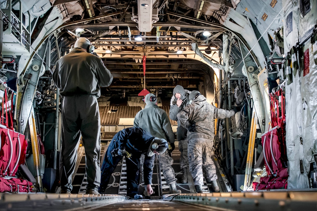 Tech. Sgt. Chris Brandal, left, performs pre-flight inspections inside a C-130H Hercules aircraft.