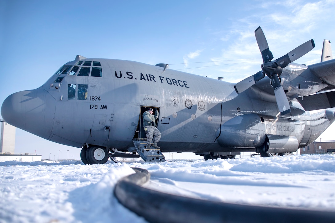 Guardsmen complete deicing and pre-flight inspections of a C-130H Hercules aircraft.