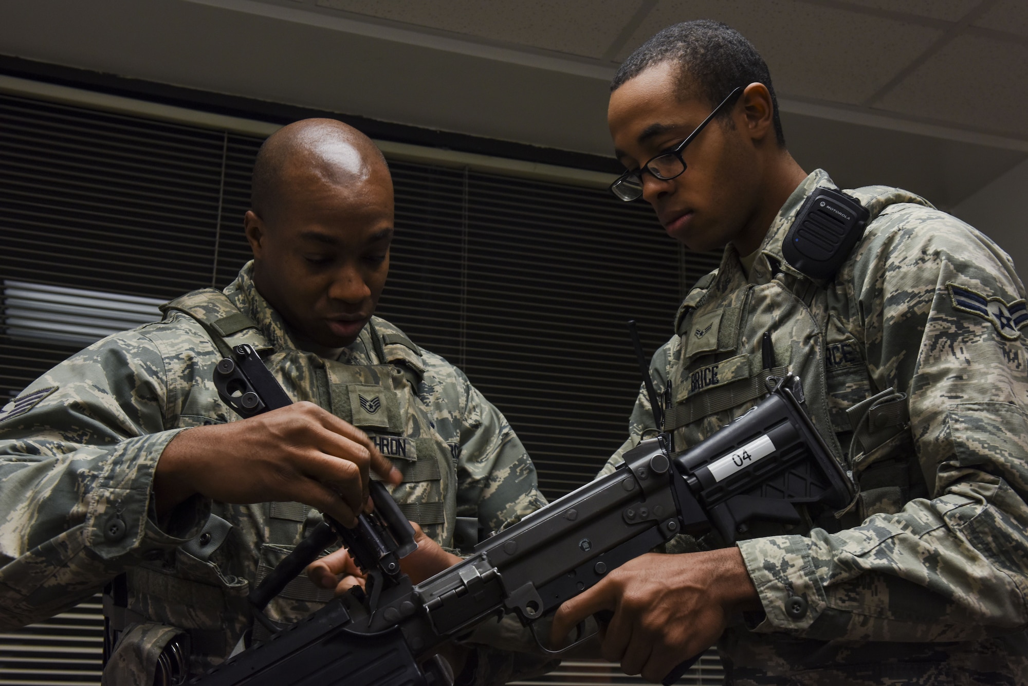 Staff Sgt. Jonathan Carthron (left) and Airman 1st Class Michael Brice, 4th Security Forces Squadron, clear a rifle in preparation for exercise Thunderdome 18-01, Jan. 11, 2018, at Seymour Johnson Air Force Base, North Carolina. After being issued a weapon, security forces personnel must visually inspect it to ensure it is in proper working order. (U.S. Air Force photo by Staff Sgt. Brittain Crolley)
