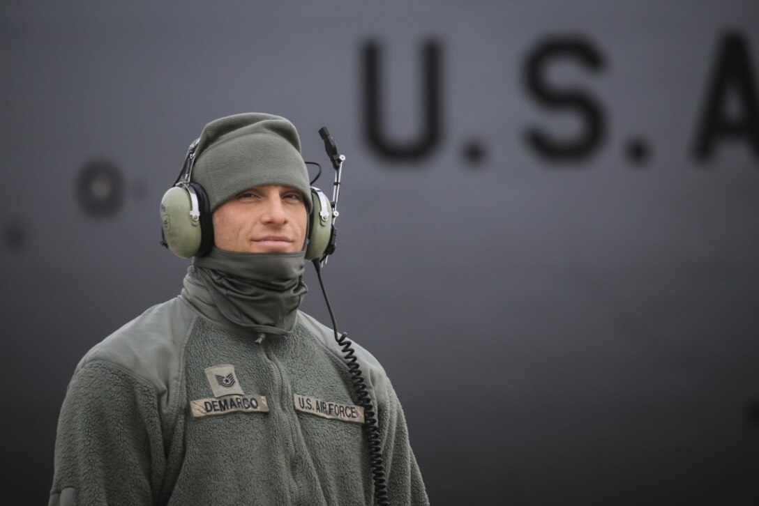 New Jersey Air National Guard KC-135R crew chief Air Force Tech. Sgt. Raymond DeMarco poses for a photo on the flightline at Joint Base McGuire-Dix-Lakehurst, N.J.