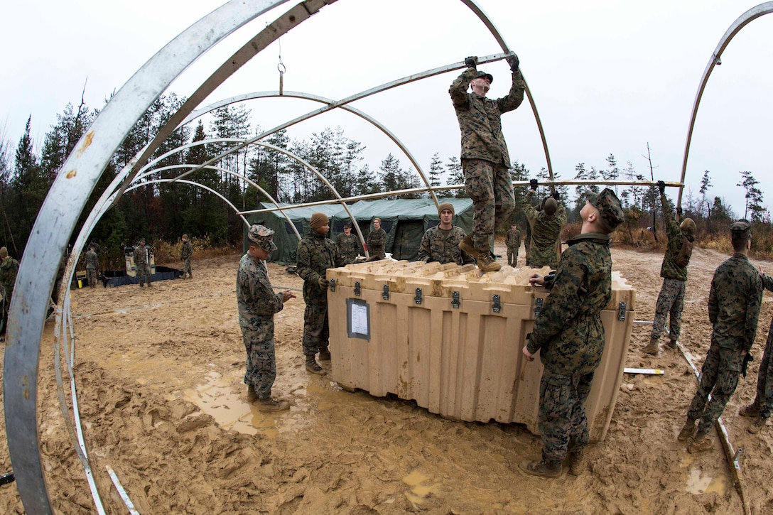 Marines set up the structural framing to building a forward operating base.