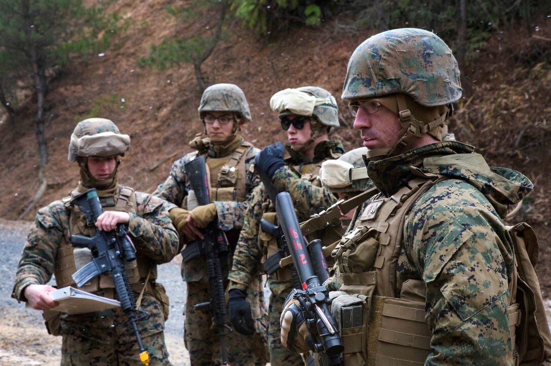 Marines receive follow-on instructions while participating in patrol zone reconnaissance training during exercise.