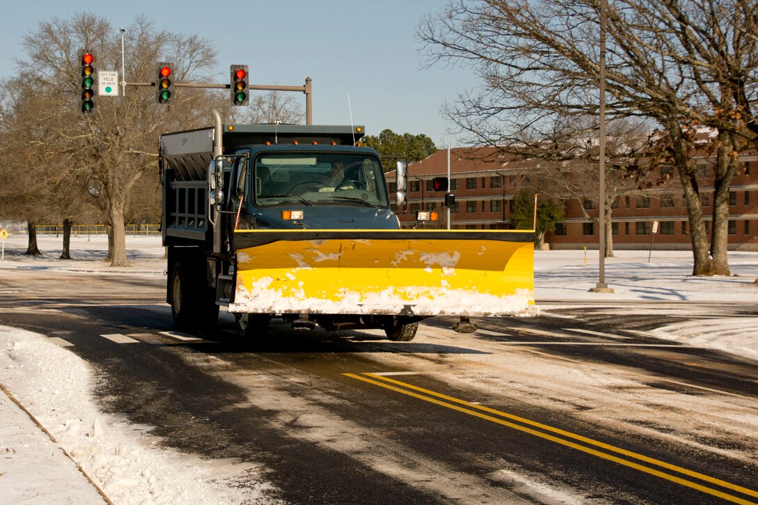 A snow plow makes its way to another portion of Little Rock Air Force Base, Ark. Jan. 16, 2018.