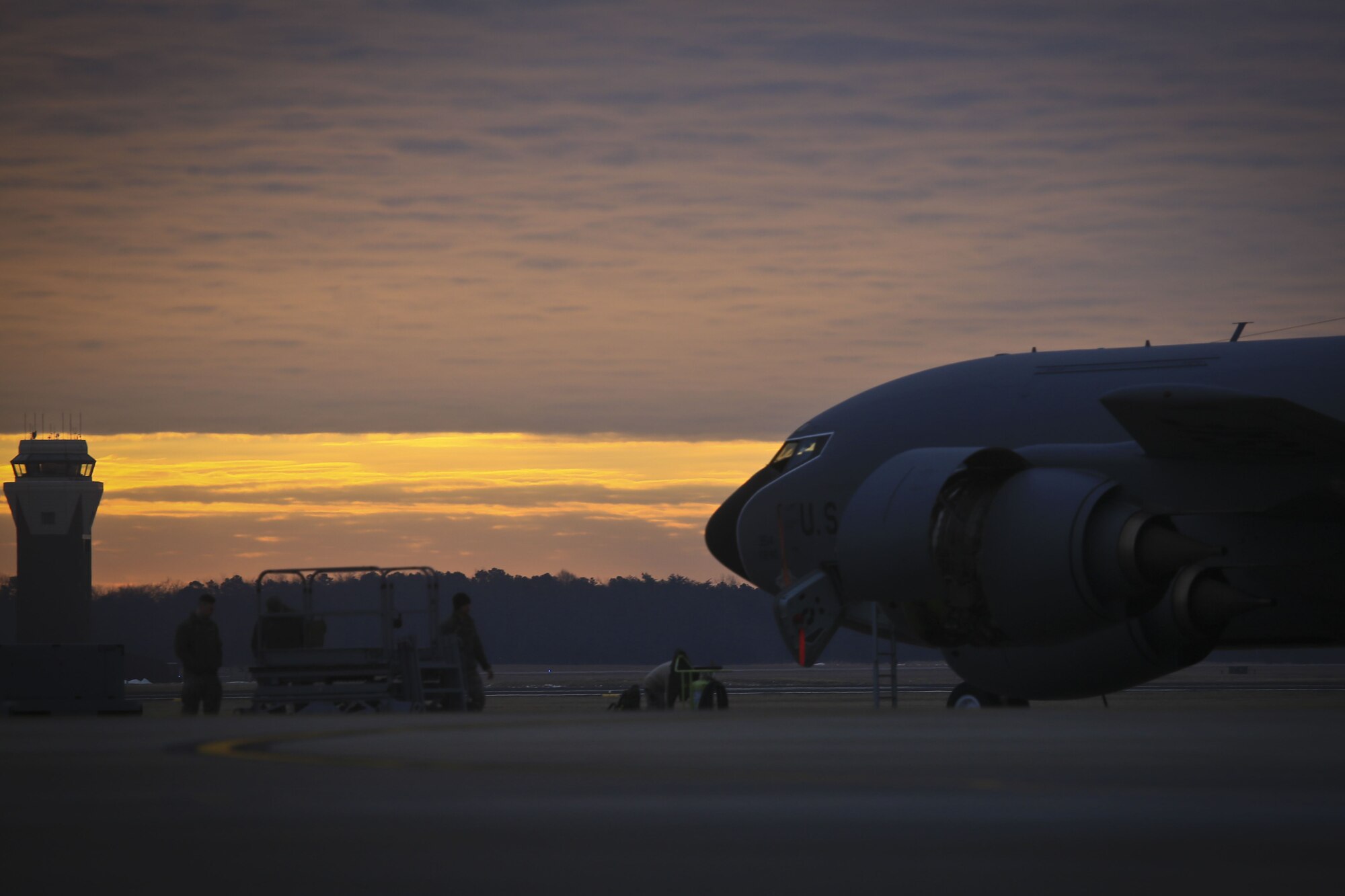 A New Jersey Air National Guard KC-135R from the 108th Wing is worked on by maintenance airmen at sunrise on Joint Base McGuire-Dix-Lakehurst, N.J., Jan. 11, 2018. (U.S. Air National Guard photo by Master Sgt. Matt Hecht)