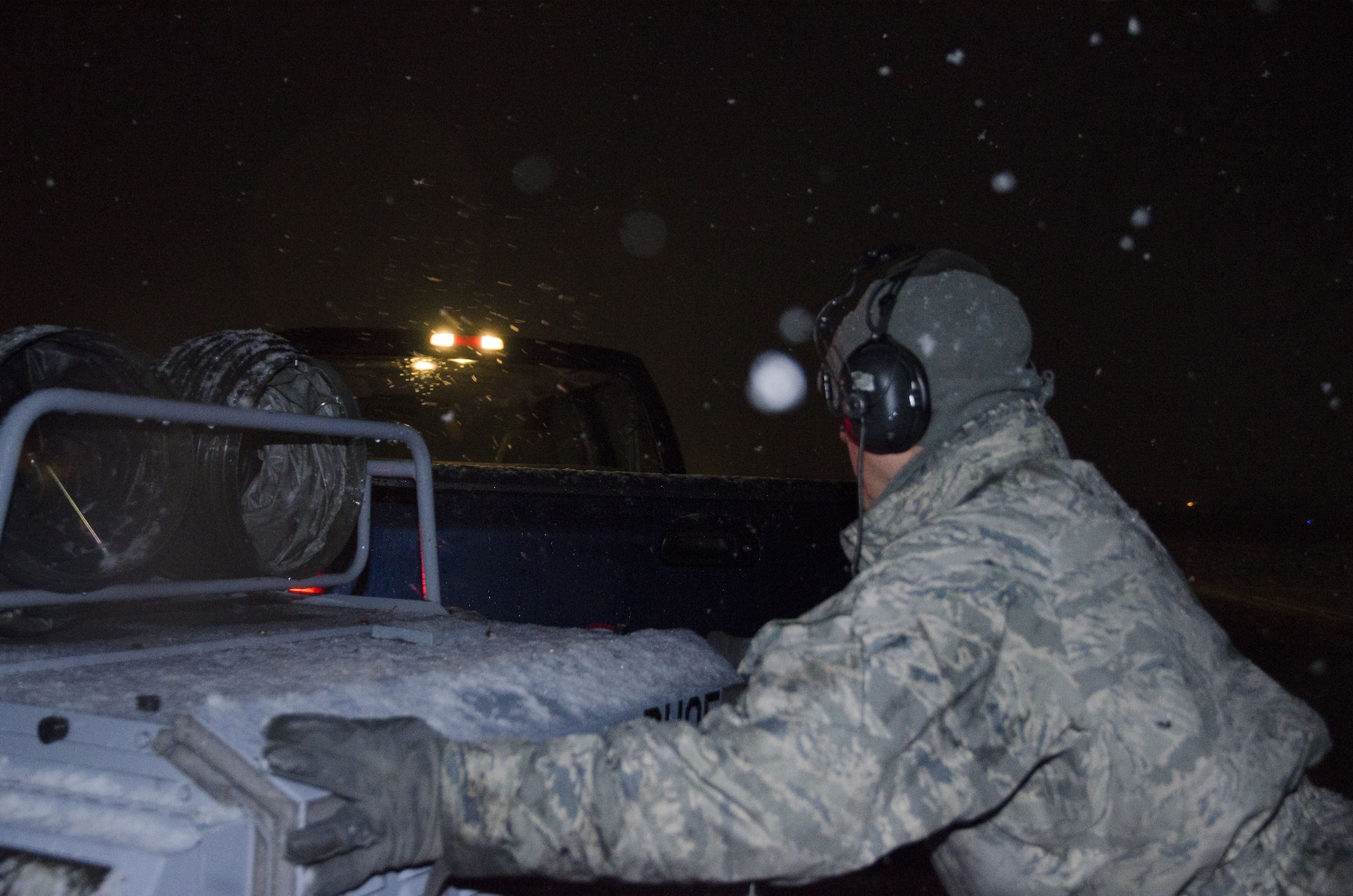 Snow falls as Master Sgt. Frank Diliberto, 108th KC-135R crew chief prepares a jet for the days flight at Joint Base McGuire-Dix-Lakehurst, N.J., Jan. 17, 2018. (U.S. Air National Guard photo by Staff Sgt. Ross A. Whitley)