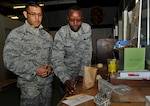 U.S. Air Force Airman 1st Class Luis Gonzalez, 20th Logistics Readiness Squadron (LRS) material management aircraft parts store (APS) apprentice, left, and Staff Sgt. Johnson Kabubei, 20th LRS material management APS noncommissioned officer in charge, prepare aircraft parts for distribution at Shaw Air Force Base (AFB), S.C., Jan. 10, 2018.