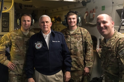 Vice President of the United States Mike Pence poses with, left to right, Air Force Tech. Sgt. Joseph Joiner and Airman 1st Class Lucas Randolph, both assigned to the 16th Airlift Squadron and far right, Tech. Sgt. Paul Doepker, 437th Aircraft Maintenance Squadron, during his flight to Bagram Airfield, Afghanistan, onboard an Air Mobility Command C-17 Globemaster III aircraft assigned to the 437th Airlift Wing, Joint Base Charleston, S.C. The Vice President visited U.S. service members and spoke on the strategy in Afghanistan. Following a 40-minute speech, Pence thanked troops for their continued service during the holiday season.