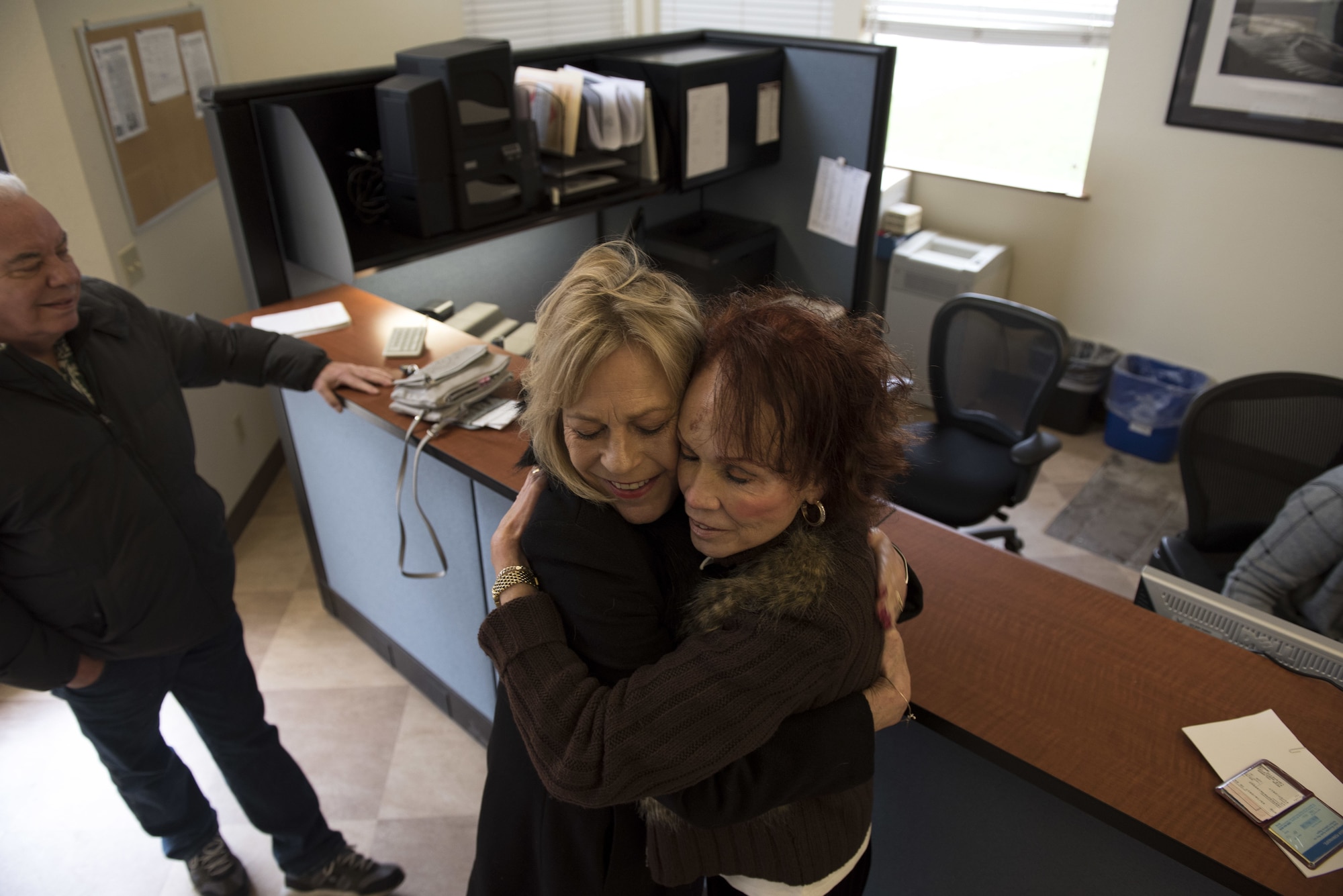 Rachel Trevino and her daughter Stella Trevino, pose for a photo at the Pass and Regristration Center Jan. 16, 2017, at Travis Air Force Base, Calif. The two came to Travis AFB in support for Rachel's mom, Karen Reed, who is a Gold Star family member who had just received a base pass. The Gold Star program first made an appearance during World War I after being placed over a service flag's blue star when a service member was killed in combat.