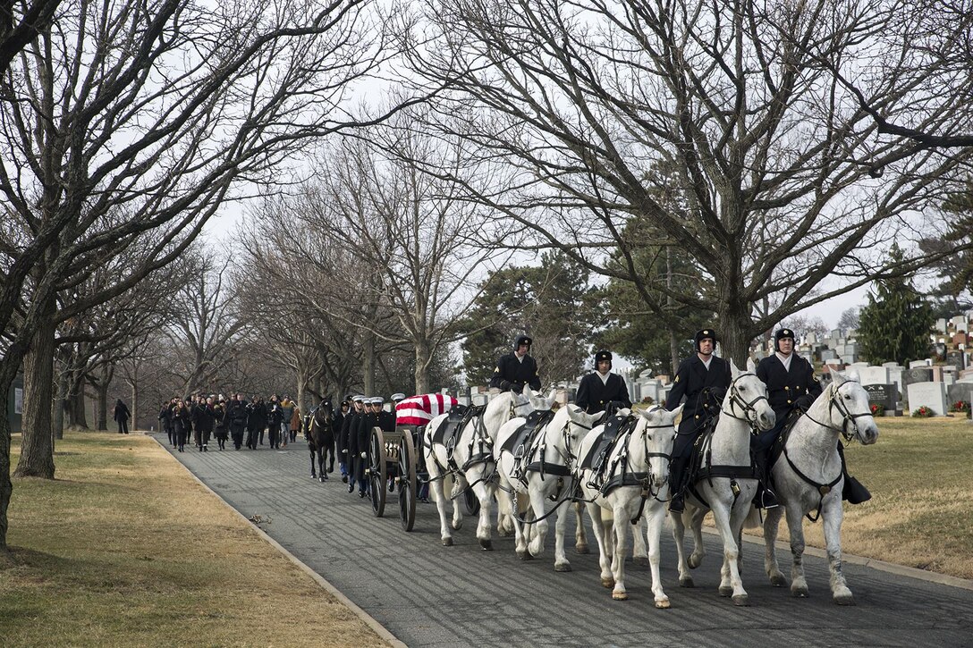 Marine Corps Body Bearers, Bravo Company, Marine Barracks Washington D.C., march behind members of the Caisson Platoon during a full honors funeral for Maj. Gen. Paul A. Fratarangelo at Arlington National Cemetery, Arlington, Va., Jan. 16, 2018.  Marine Barracks Washington is home to the Marines who provide support for all Marine Corps funerals and many high-ranking government officials’ funerals within the National Capital Region. (Official U.S. Marine Corps photo by Cpl. Robert Knapp/Released)