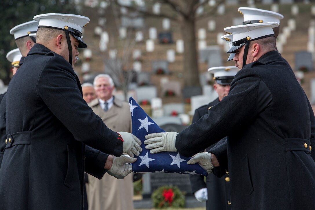 Marine Corps Body Bearers, Bravo Company, Marine Barracks Washington D.C., fold the National Flag during a full honors funeral for Maj. Gen. Paul A. Fratarangelo at Arlington National Cemetery, Arlington, Va., Jan. 16, 2018. Marine Barracks Washington is home to the Marines who provide support for all Marine Corps funerals and many high-ranking government officials’ funerals within the National Capital Region. (Official U.S. Marine Corps photo by Cpl. Robert Knapp/Released)