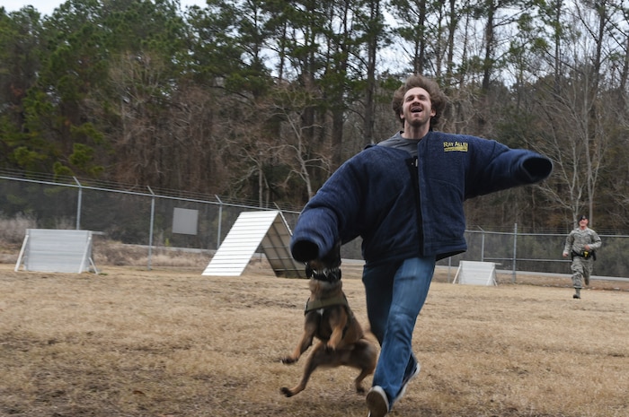 Mike Krieg, South Carolina Stingrays defensemen, participates in a military working dog demonstration with Staff Sgt. Joshua Plucinski, 628th Security Forces Squadron MWD handler at the MWD building, Jan. 10, 2018.