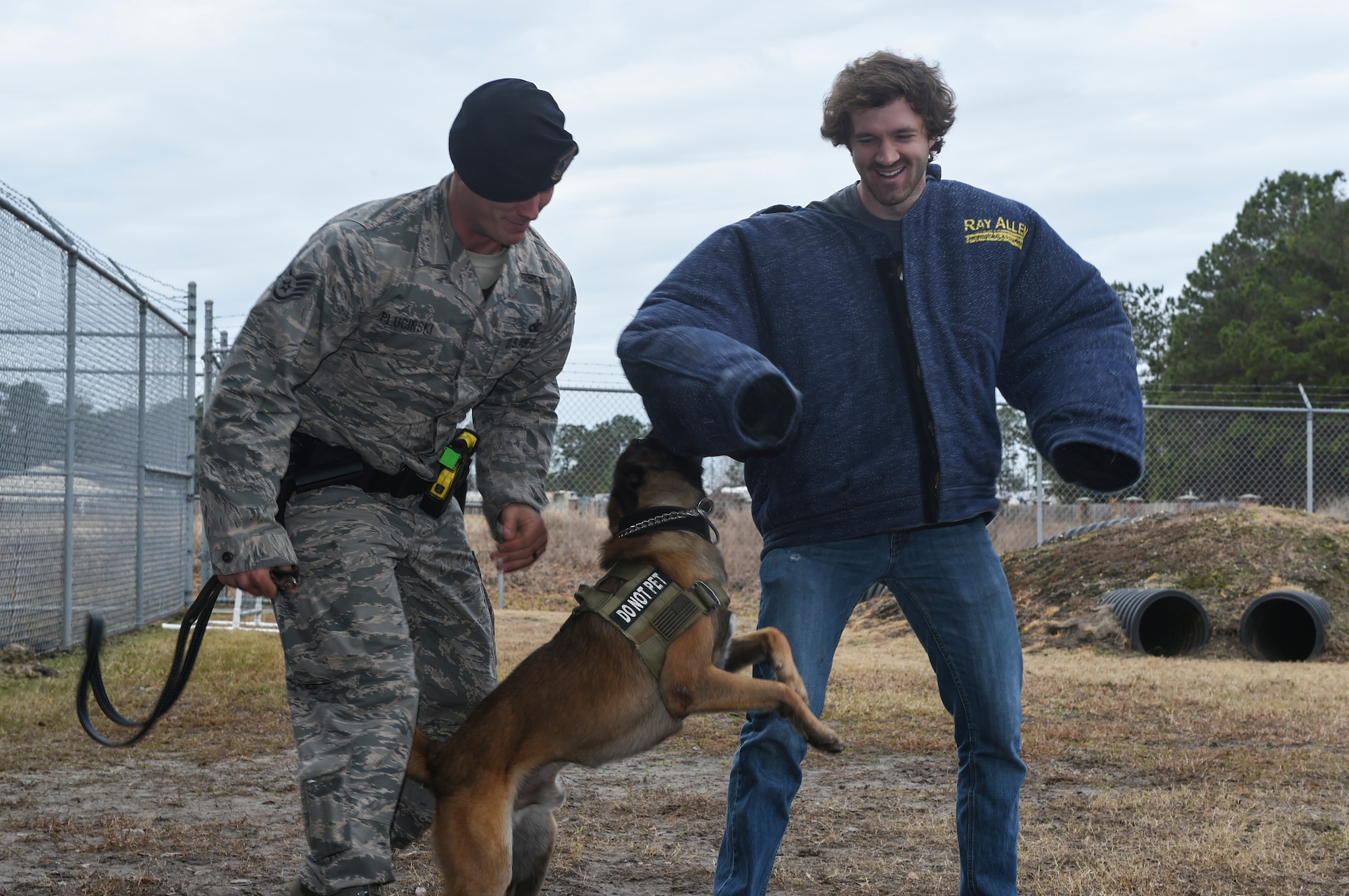 Mike Krieg, South Carolina Stingrays defensemen, participates in a military working dog demonstration with Staff Sgt. Joshua Plucinski, 628th Security Forces Squadron MWD handler at the MWD building, Jan. 10, 2018.