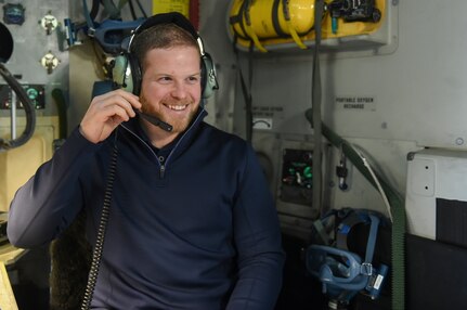 Ryan Warsofsky, South Carolina Stingrays head coach, tries on one of the headsets used by aircrew members on a C-17 Globemaster III, Jan. 10, 2018.
