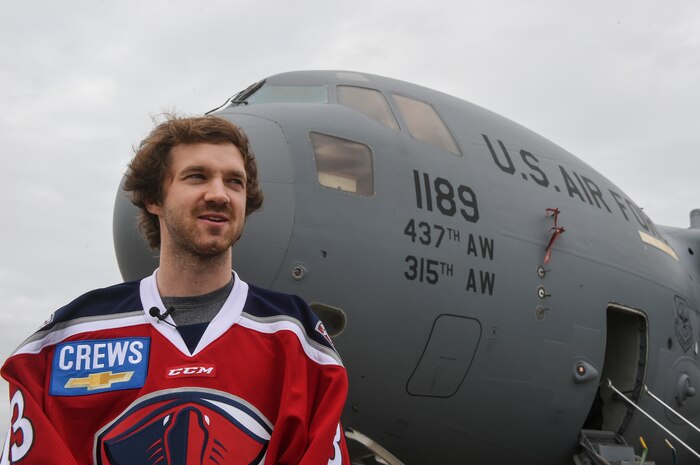 Mike Krieg, South Carolina Stingrays defensemen, stands in front of a C-17 Globemaster III on the flightline here, Jan. 10, 2018.