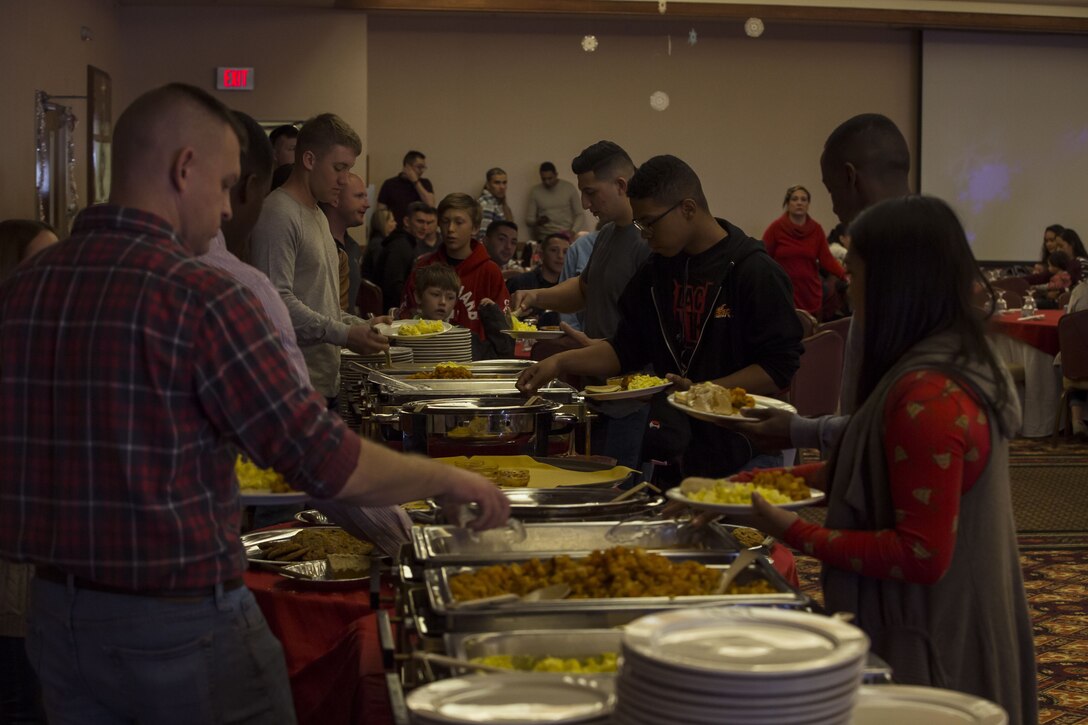 Service  members, Department of Defense employee,s and their families attend the Headquarters and Headquarters Squadron Christmas party at the sonoran pueblo on Marine Corps Air Station Yuma Ariz., Dec. 9, 2017. The christmas party was held for the families and services members to enjoy games arts and crafts and spend time together as one big family. (U.S. Marine Corps Photo by Cpl. Christian Cachola)