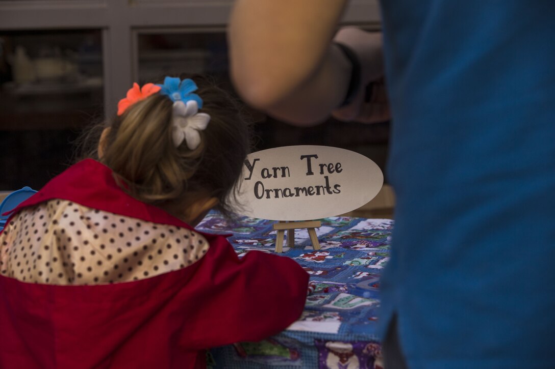 Service  members, Department of Defense employee,s and their families attend the Headquarters and Headquarters Squadron Christmas party at the sonoran pueblo on Marine Corps Air Station Yuma Ariz., Dec. 9, 2017. The christmas party was held for the families and services members to enjoy games arts and crafts and spend time together as one big family. (U.S. Marine Corps Photo by Cpl. Christian Cachola)