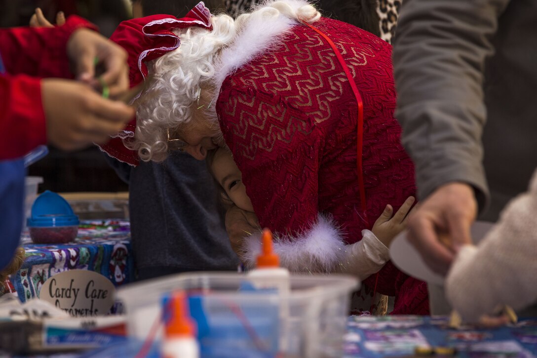 Service  members, Department of Defense employee,s and their families attend the Headquarters and Headquarters Squadron Christmas party at the sonoran pueblo on Marine Corps Air Station Yuma Ariz., Dec. 9, 2017. The christmas party was held for the families and services members to enjoy games arts and crafts and spend time together as one big family. (U.S. Marine Corps Photo by Cpl. Christian Cachola)