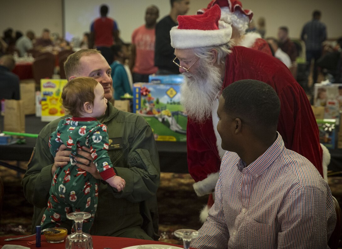 Service  members, Department of Defense employee,s and their families attend the Headquarters and Headquarters Squadron Christmas party at the sonoran pueblo on Marine Corps Air Station Yuma Ariz., Dec. 9, 2017. The christmas party was held for the families and services members to enjoy games arts and crafts and spend time together as one big family. (U.S. Marine Corps Photo by Lance Cpl. Joel Soriano)