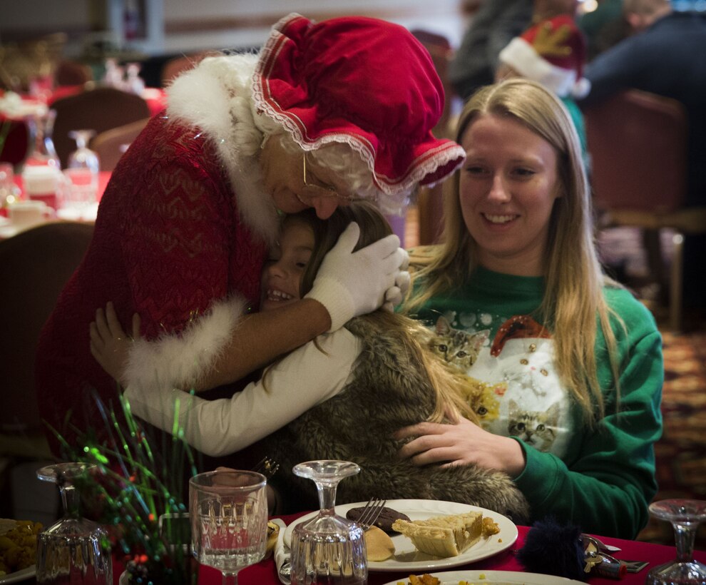 Service  members, Department of Defense employee,s and their families attend the Headquarters and Headquarters Squadron Christmas party at the sonoran pueblo on Marine Corps Air Station Yuma Ariz., Dec. 9, 2017. The christmas party was held for the families and services members to enjoy games arts and crafts and spend time together as one big family. (U.S. Marine Corps Photo by Lance Cpl. Joel Soriano)
