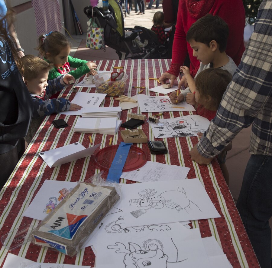 Service  members, Department of Defense employee,s and their families attend the Headquarters and Headquarters Squadron Christmas party at the sonoran pueblo on Marine Corps Air Station Yuma Ariz., Dec. 9, 2017. The christmas party was held for the families and services members to enjoy games arts and crafts and spend time together as one big family. (U.S. Marine Corps Photo by Lance Cpl. Joel Soriano)