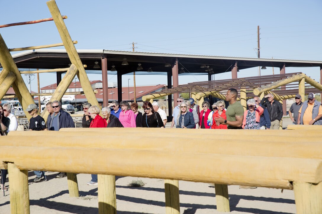 Guests participating in the Marine Corps Air Station (MCAS) Yuma Winter Tours observe the capabilities of the station, a demonstration of the K-9 unit, and an obstacle course demonstration at various locations on MCAS Yuma, Ariz., Dec. 12, 2017. The Winter Tours have not been conducted for the past two years, but have been resumed by Col. David A. Suggs, the station commanding officer, to build a better relationship with the community. (U.S. Marine Corps photo taken by Cpl. Ernest Grant)