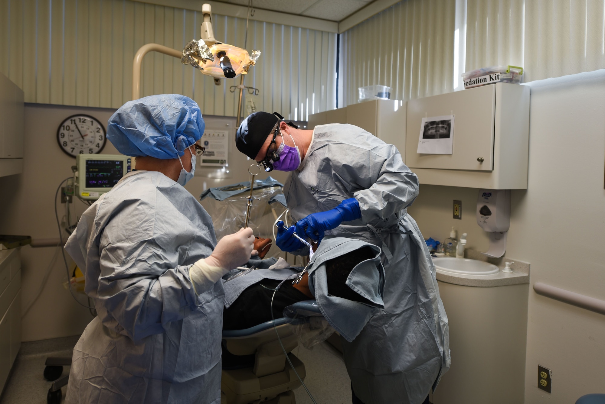 Lt. Col. Curt Hayes, 90th Medical Group oral surgeon, injects numbing medicine into his patient before proceeding with the wisdom tooth removal surgery at F.E. Warren Air Force Base, Wyo., Jan. 16, 2018. The patient received several rounds of numbing medication, time-released pain reliever, and sedation. Most dental clinics prescribe patients with narcotics after surgery resulting in a longer recovery. (U.S. Air Force photo by Airman 1st Class Abbigayle Wagner)