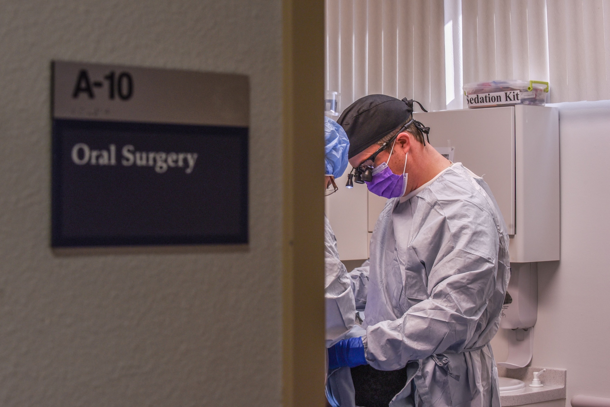 Lt. Col. Curt Hayes, 90th Medical Group oral surgeon, prepares a patient to have their wisdom teeth removed at F.E. Warren Air Force Base, Wyo., Jan. 16, 2018. Wisdom teeth are typically removed due to the pain they may cause or the impact on the surrounding teeth. The procedure is performed with a time-released pain reliever and Tylenol, reducing the need for narcotics and allowing the patient to return to work in approximately three days. (U.S. Air Force photo by Airman 1st Class Abbigayle Wagner)